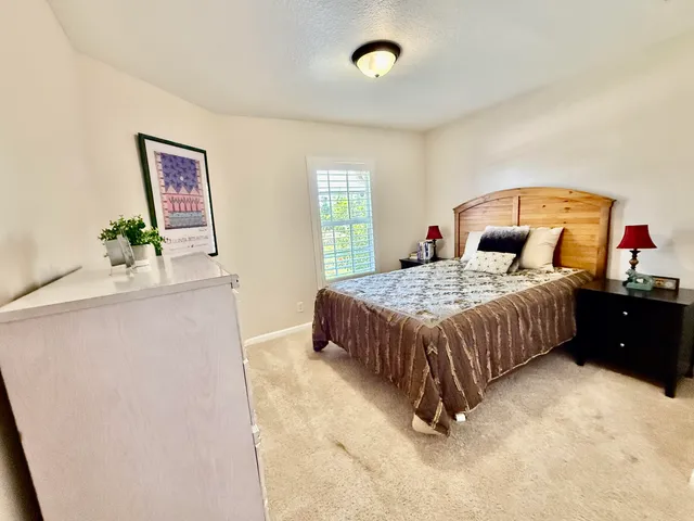 a bedroom with a bed and a dresser