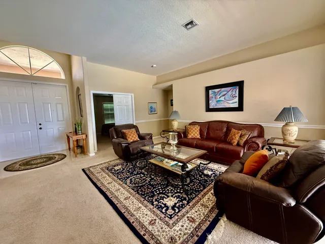 a living room with furniture a rug and a window