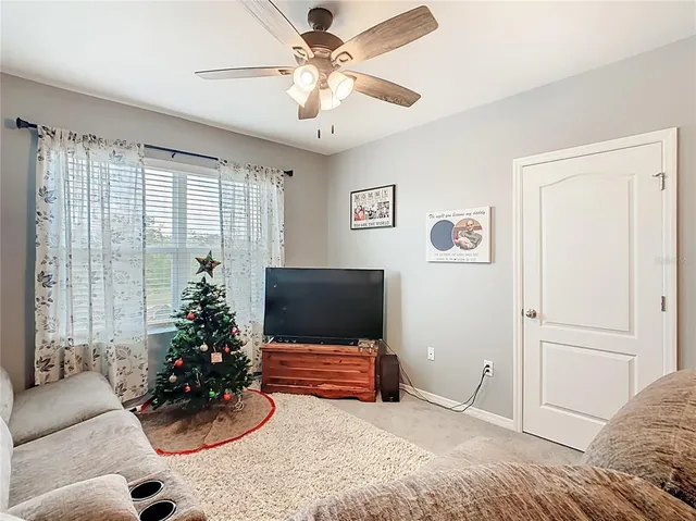 a bedroom with a bed potted plant and a window