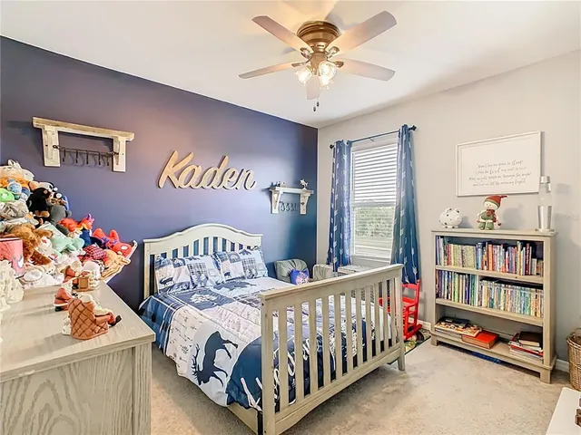 a bedroom with a bed and a book shelf