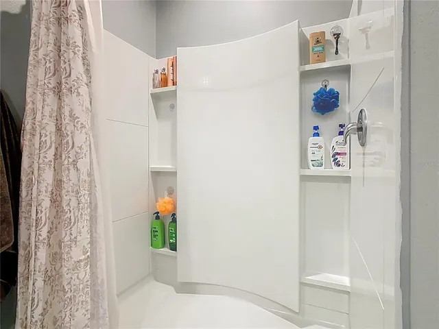 a view of a hallway with paintings on the wall