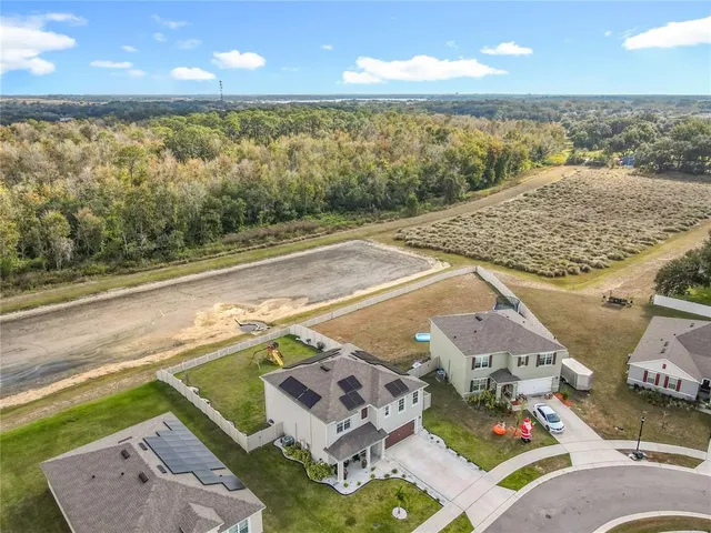 a aerial view of a house with a yard
