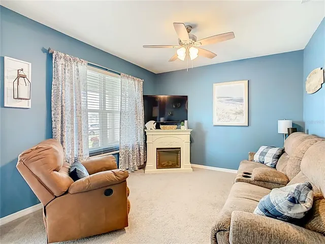 a living room with furniture flat screen tv and a fireplace