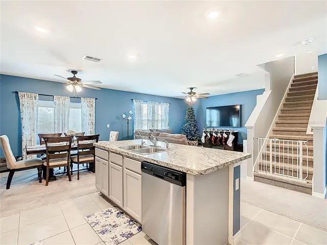 a large kitchen with a table and chairs