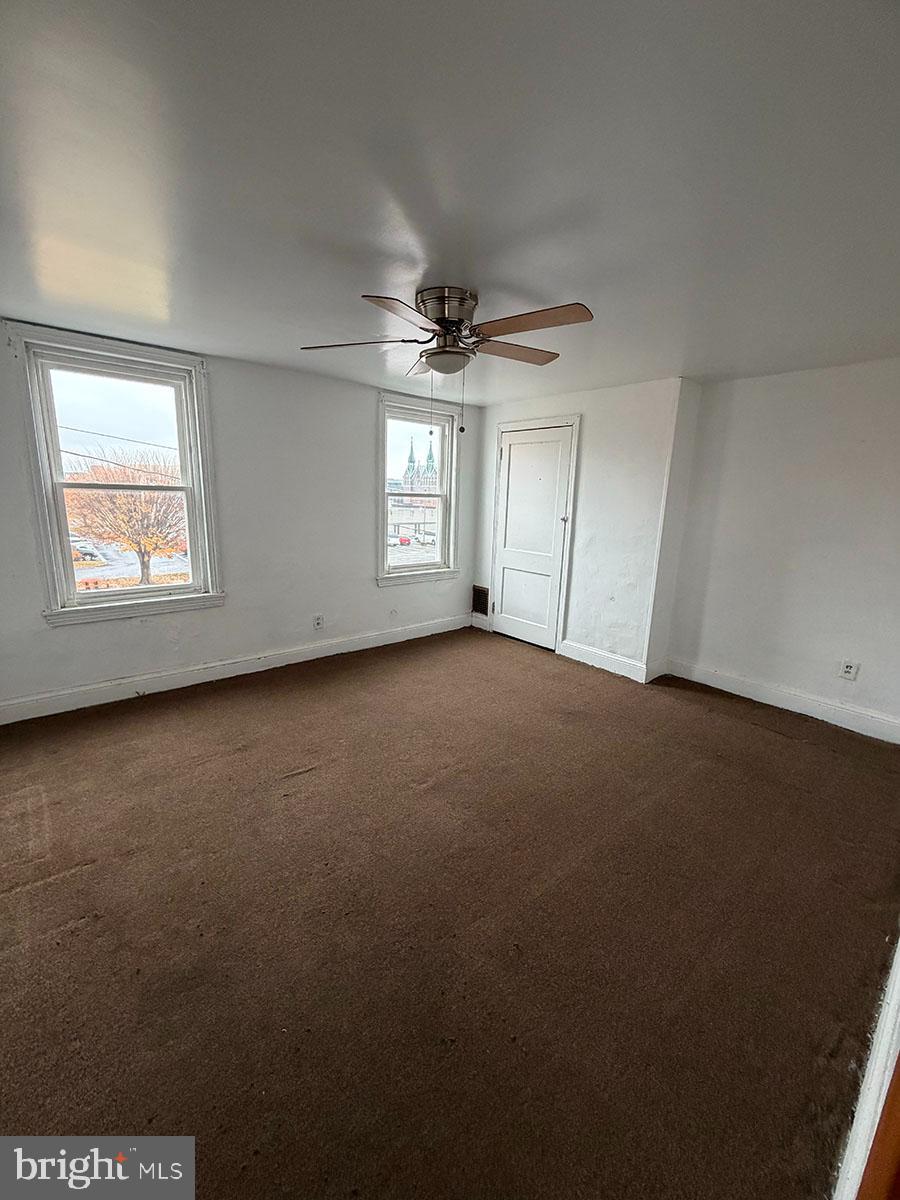 2736 A Street Philadelphia, PA 19134 - Photo 15 of 24 an empty room with a window and a ceiling fan