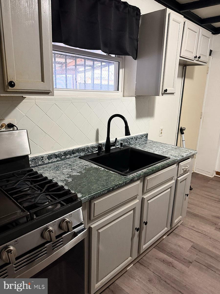 2736 A Street Philadelphia, PA 19134 - Photo 6 of 24 a close view of a stove a sink and dishwasher with wooden floor