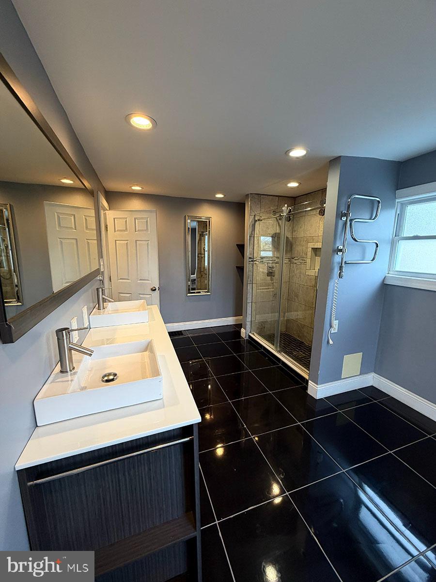2736 A Street Philadelphia, PA 19134 - Photo 10 of 24 a bathroom with a sink mirror and shower