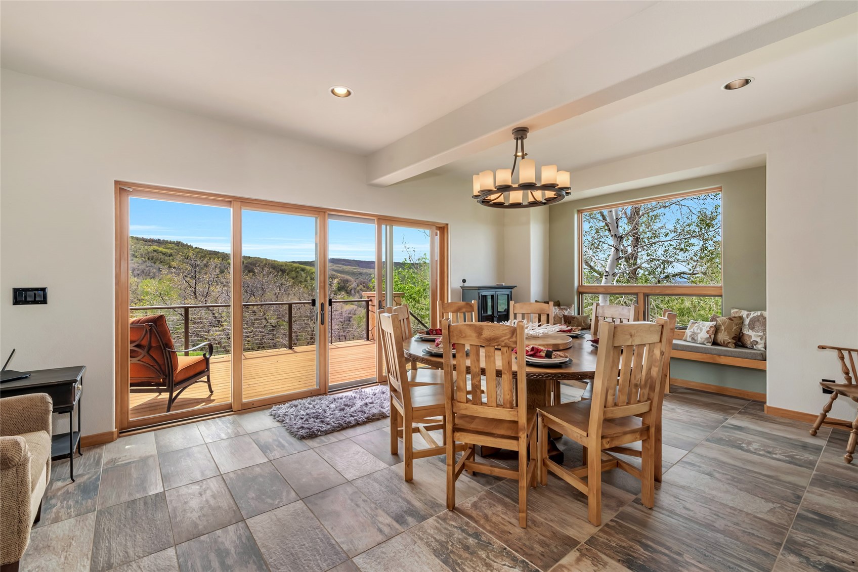 31485 Deerwood Ranch Road Steamboat Springs, CO 80487 - Photo 21 of 49 a dining room with furniture a chandelier and wooden floor
