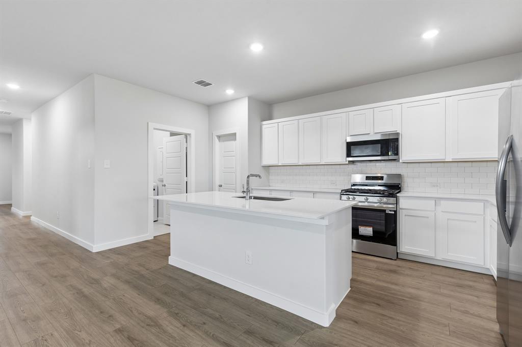 1428 Companero Street Haslet, TX 76052 - Photo 7 of 33 Kitchen in the Oscar home plan by Trophy Signature Homes – REPRESENTATIVE PHOTO