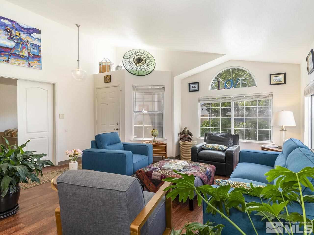 6030 Citation Court Reno, NV 89523 - Photo 3 of 18 a living room with furniture a clock and windows
