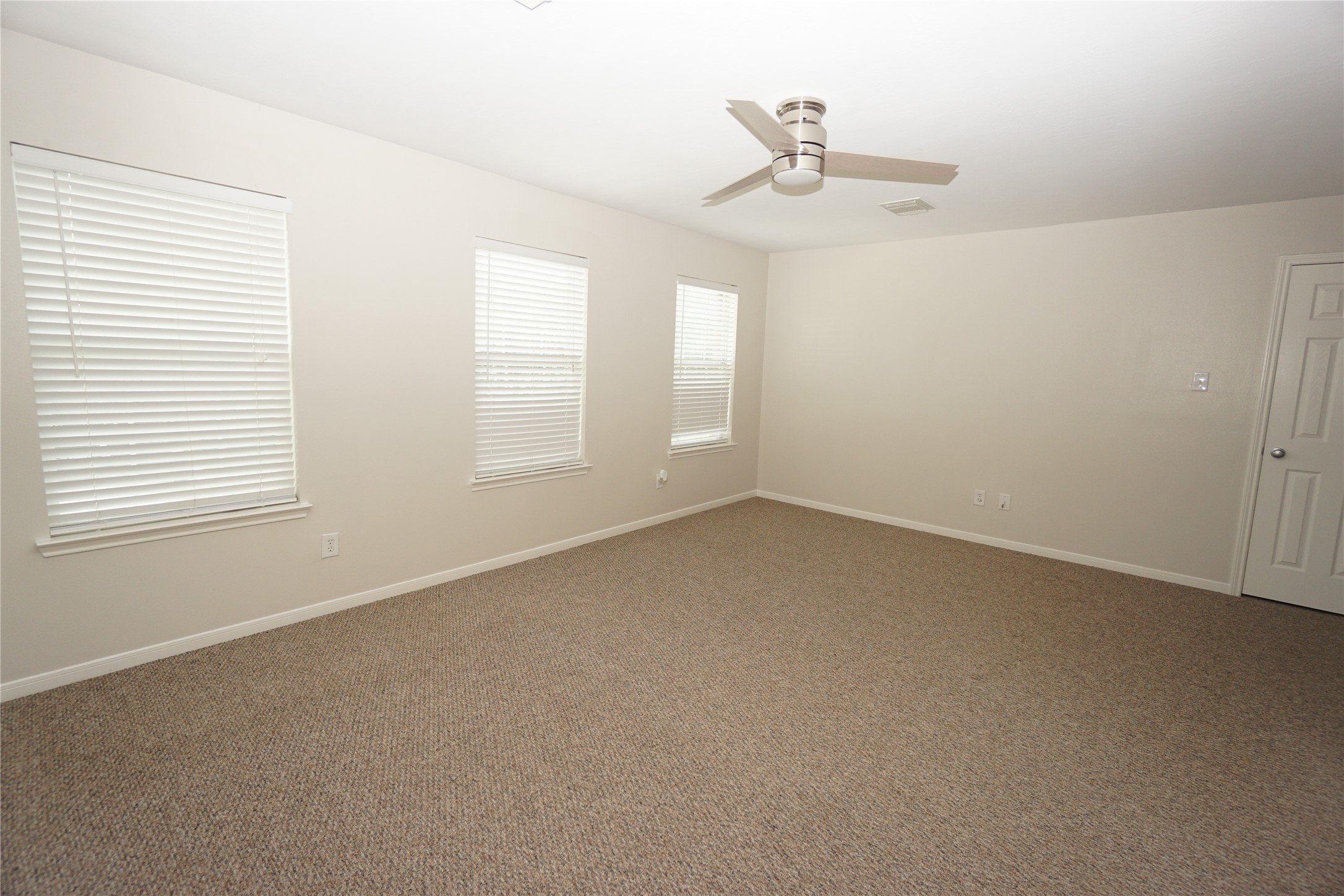 2434 Ranch Hollow Court Katy, TX 77494 - Photo 13 of 20 an empty room with windows and fan