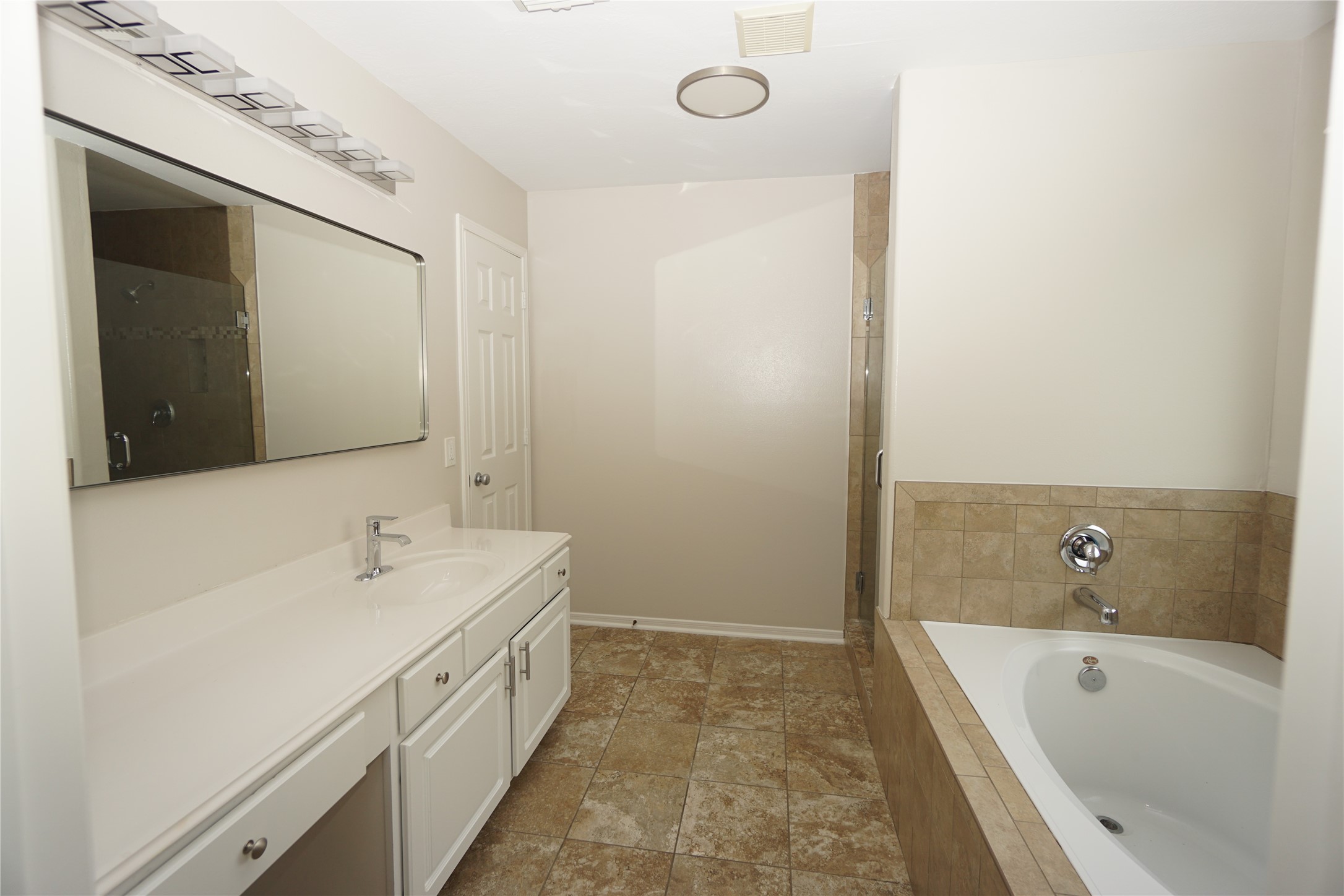 2434 Ranch Hollow Court Katy, TX 77494 - Photo 14 of 20 a spacious bathroom with a tub sink and mirror