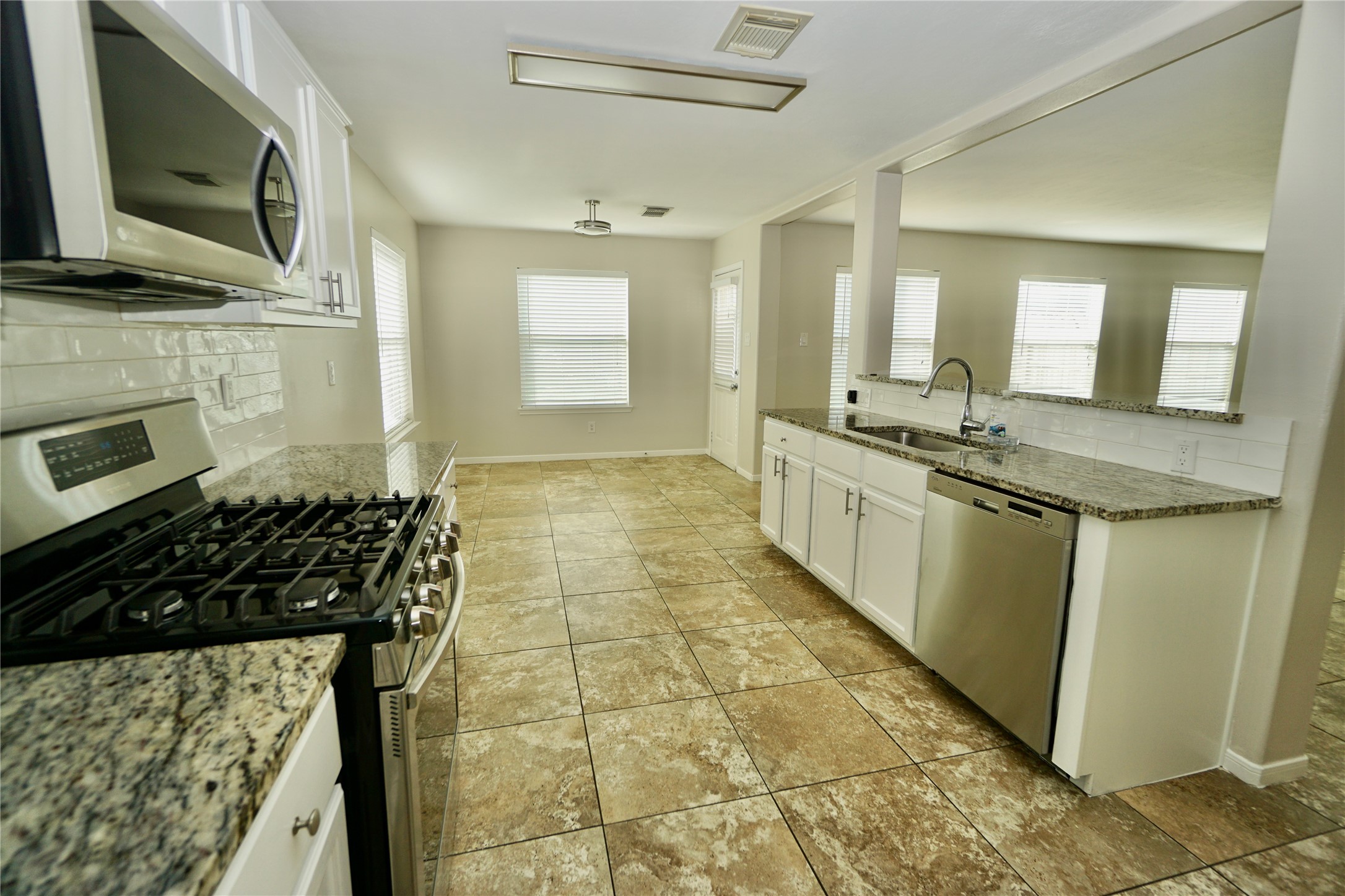 2434 Ranch Hollow Court Katy, TX 77494 - Photo 7 of 20 a bathroom with a granite countertop sink a mirror and a shower