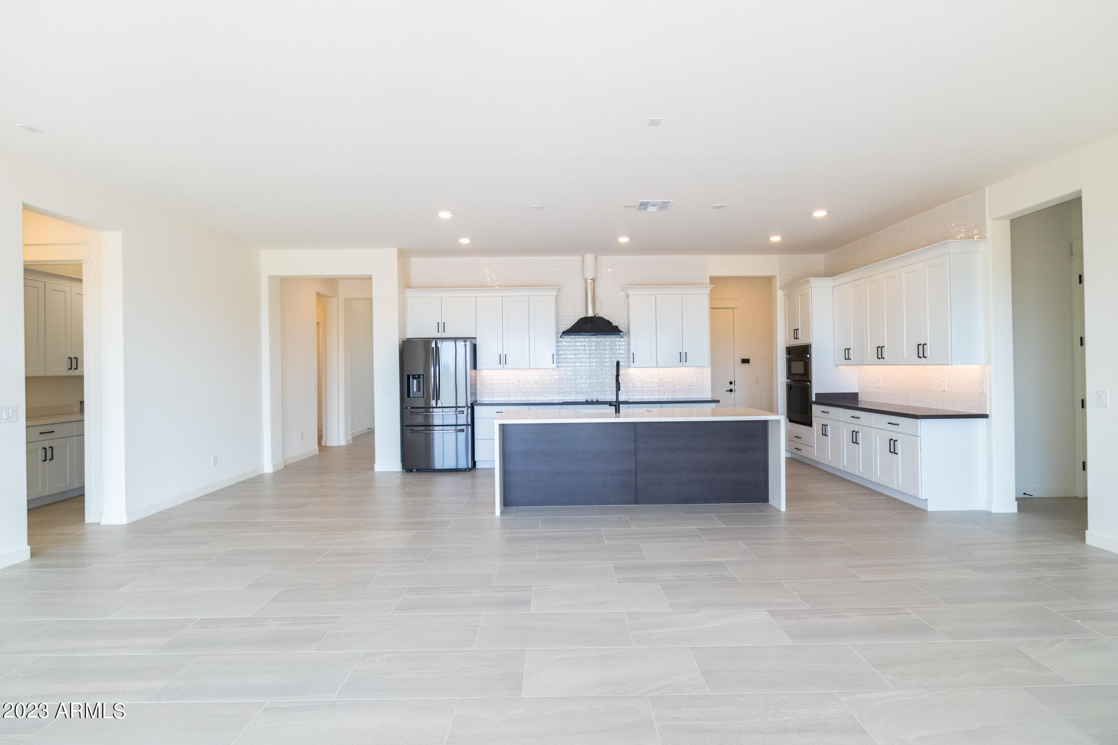 522 North Sun Road Apache Junction, AZ 85119 - Photo 21 of 46 a large white kitchen with kitchen island a sink stainless steel appliances and cabinets
