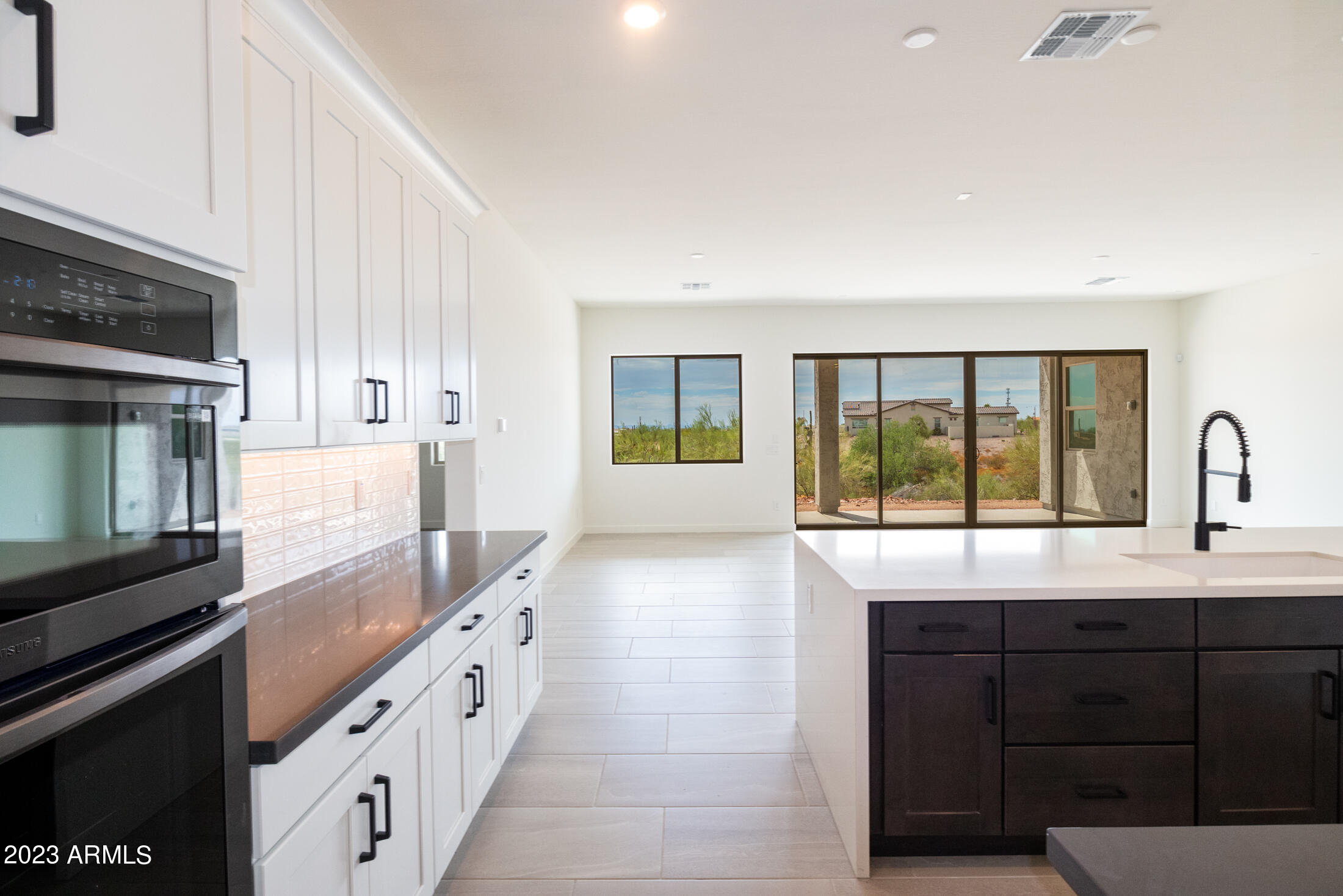 522 North Sun Road Apache Junction, AZ 85119 - Photo 25 of 46 a large kitchen with granite countertop a stove a sink and a granite counter tops