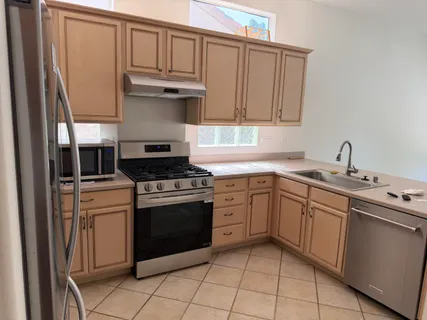 a kitchen with cabinets appliances and a sink