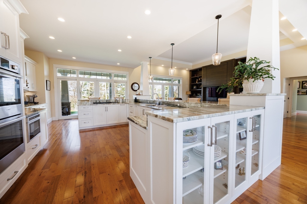 1776 Old Turnpike Road Oakham, MA 01068 - Photo 9 of 42 a kitchen with stainless steel appliances kitchen island granite countertop a stove a sink a refrigerator and a wooden floor