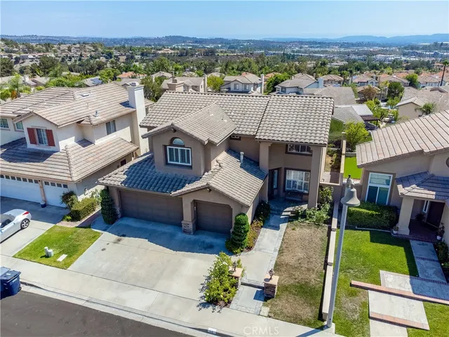 an aerial view of a house with a garden and plants