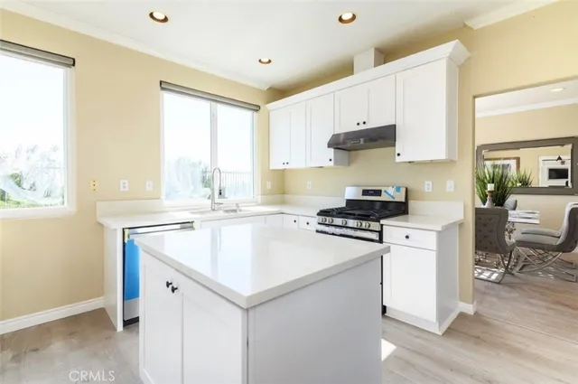 a kitchen with a stove a sink and a refrigerator