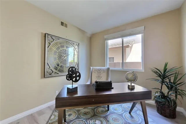a view of a workspace with a table and chair