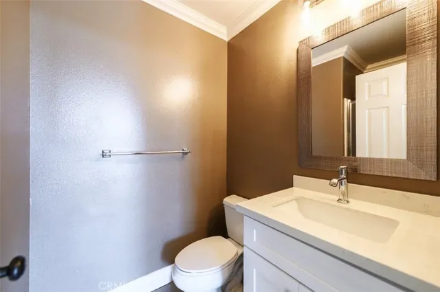 a bathroom with a sink a toilet and mirror