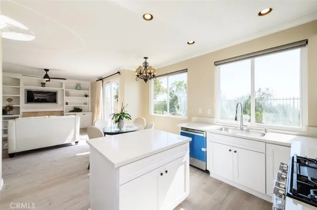a kitchen with a sink stove and cabinets
