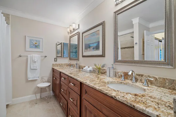 a bathroom with a granite countertop sink mirror and toilet