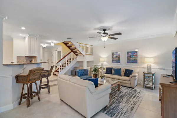 a living room with furniture and a chandelier