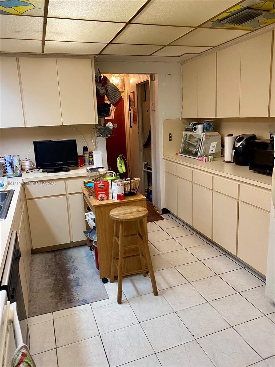 911 Northwest 138th Street Miami, FL 33168 - Photo 11 of 14 a room with a washing machine and cabinets