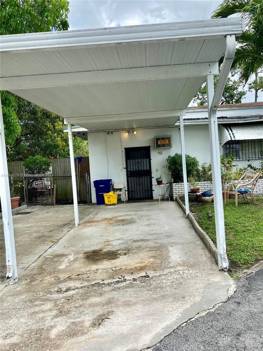 911 Northwest 138th Street Miami, FL 33168 - Photo 2 of 14 a view of a chair and table in backyard of the house