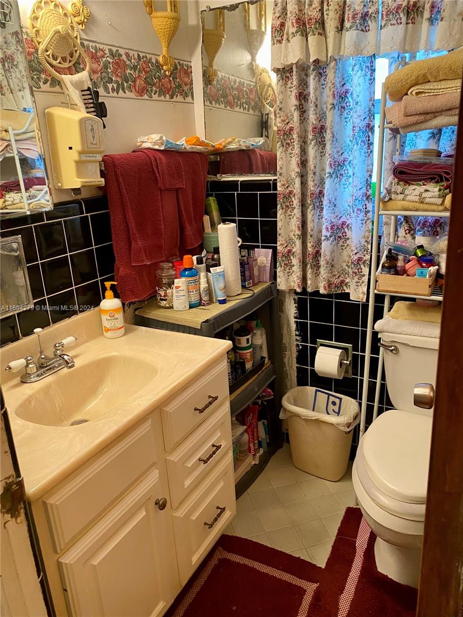 911 Northwest 138th Street Miami, FL 33168 - Photo 5 of 14 a bathroom with a sink a toilet and shower