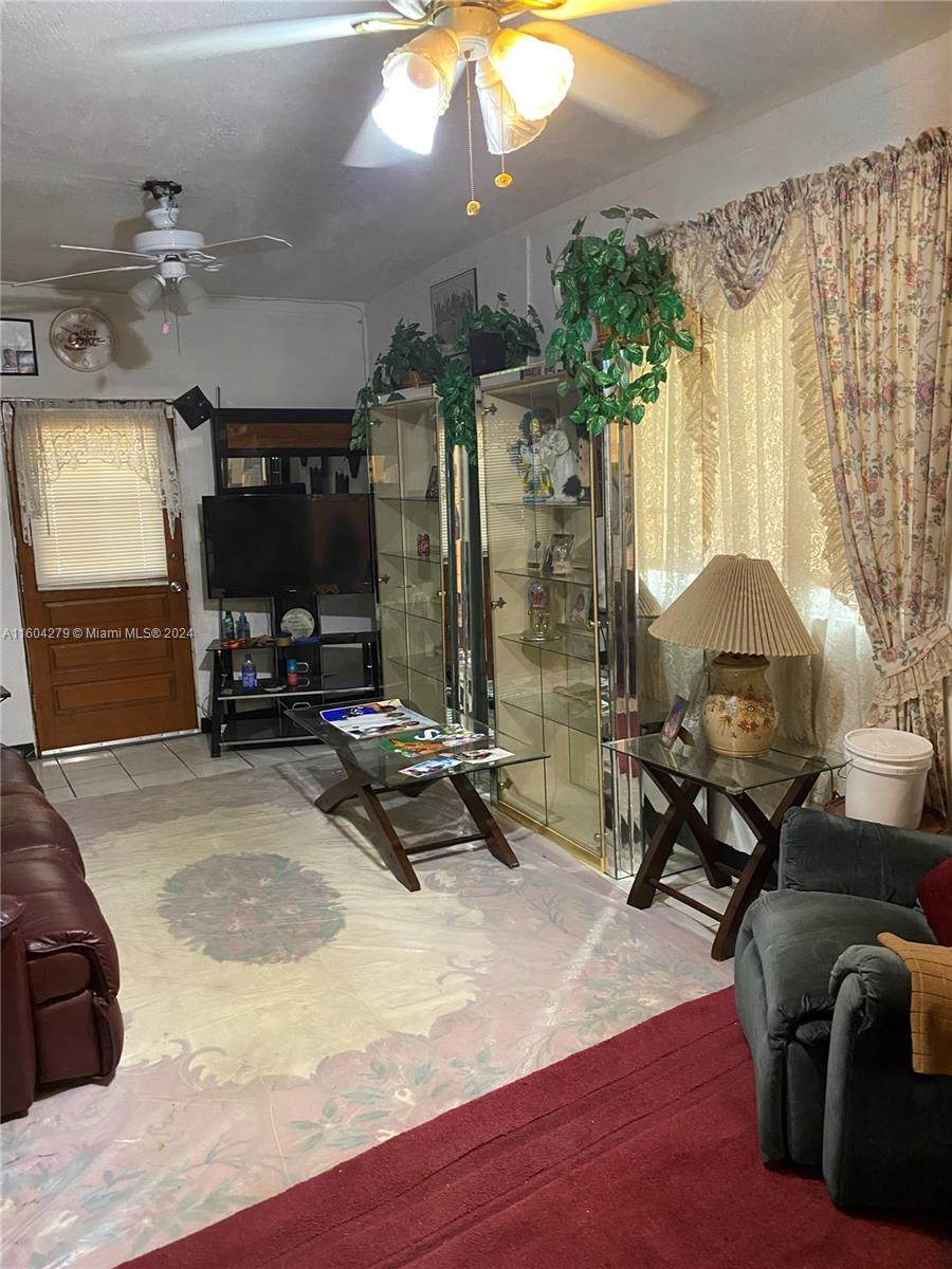 911 Northwest 138th Street Miami, FL 33168 - Photo 6 of 14 a living room with furniture a lamp and a chandelier