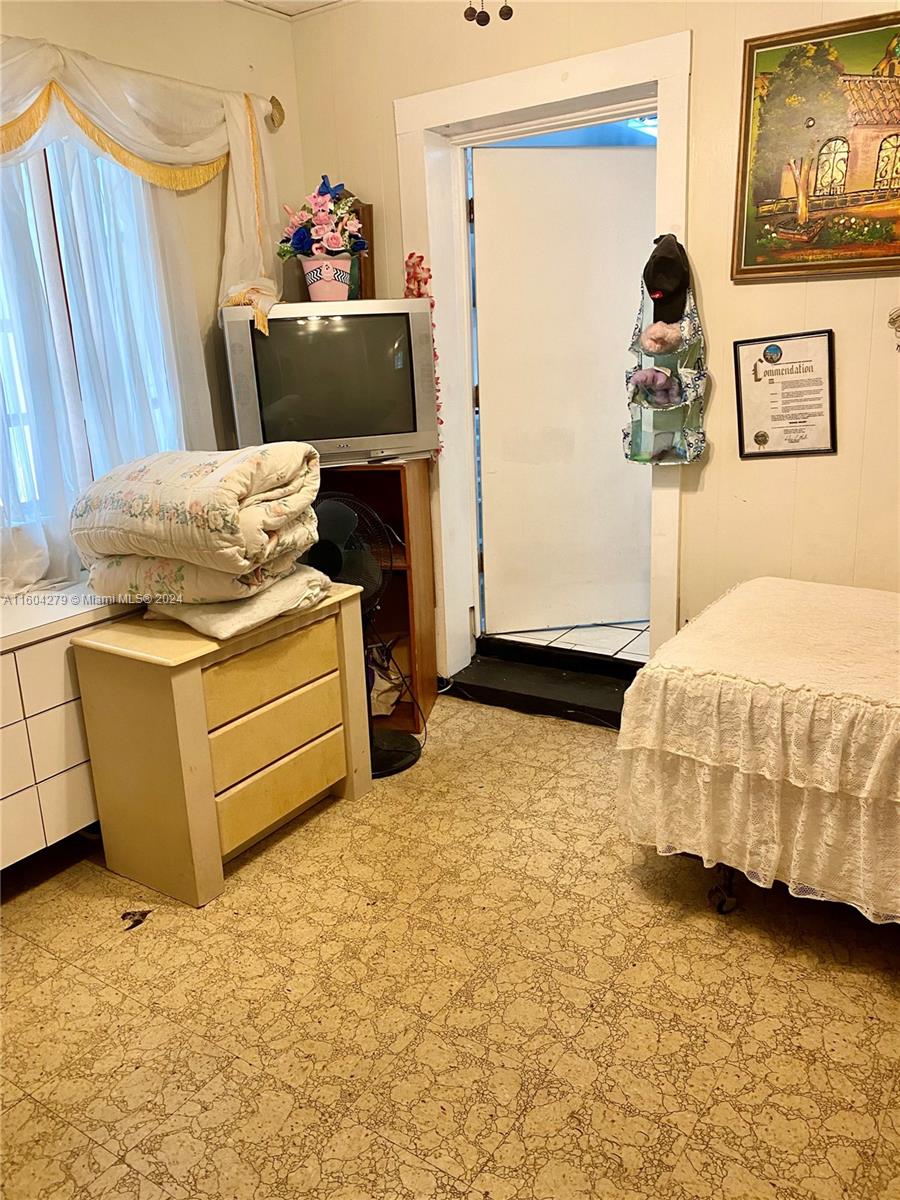 911 Northwest 138th Street Miami, FL 33168 - Photo 9 of 14 a bedroom with a bed and a dresser