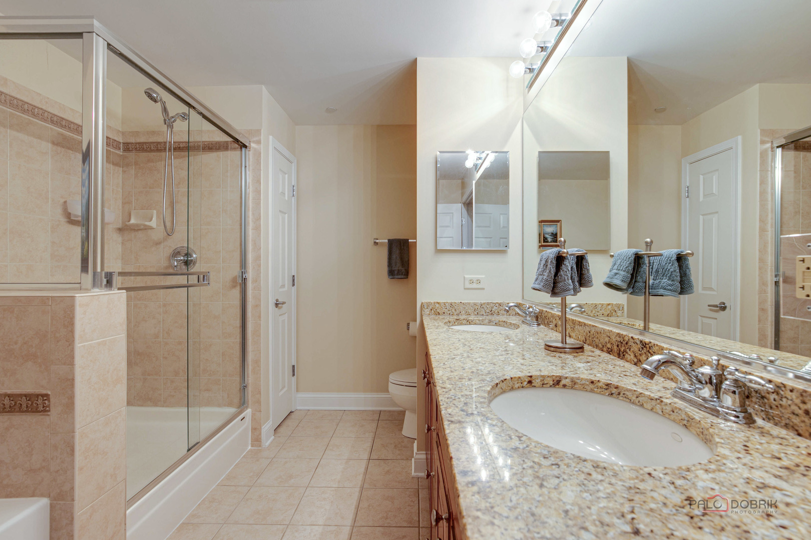 125 North Buffalo Grove Road, Unit 306 Buffalo Grove, IL 60089 - Photo 14 of 19 a bathroom with a granite countertop sink and a mirror