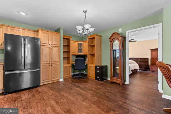 a view of a kitchen with a refrigerator and microwave
