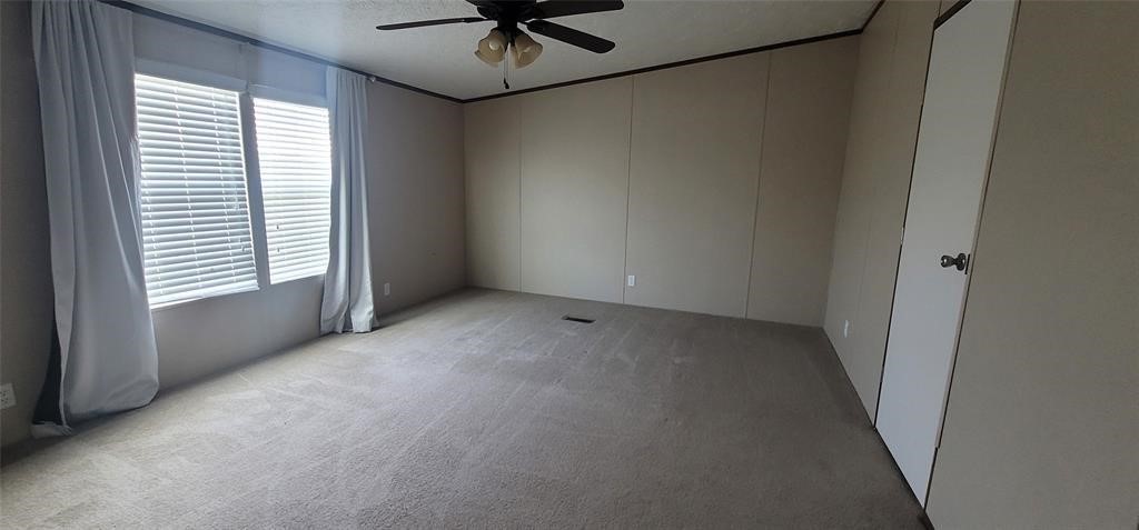 28625 Clay Road, Unit C Katy, TX 77493 - Photo 11 of 18 an empty room with a window and a fan
