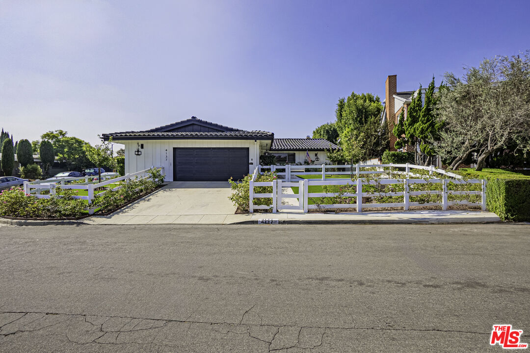 a view of a house with a yard and a garage