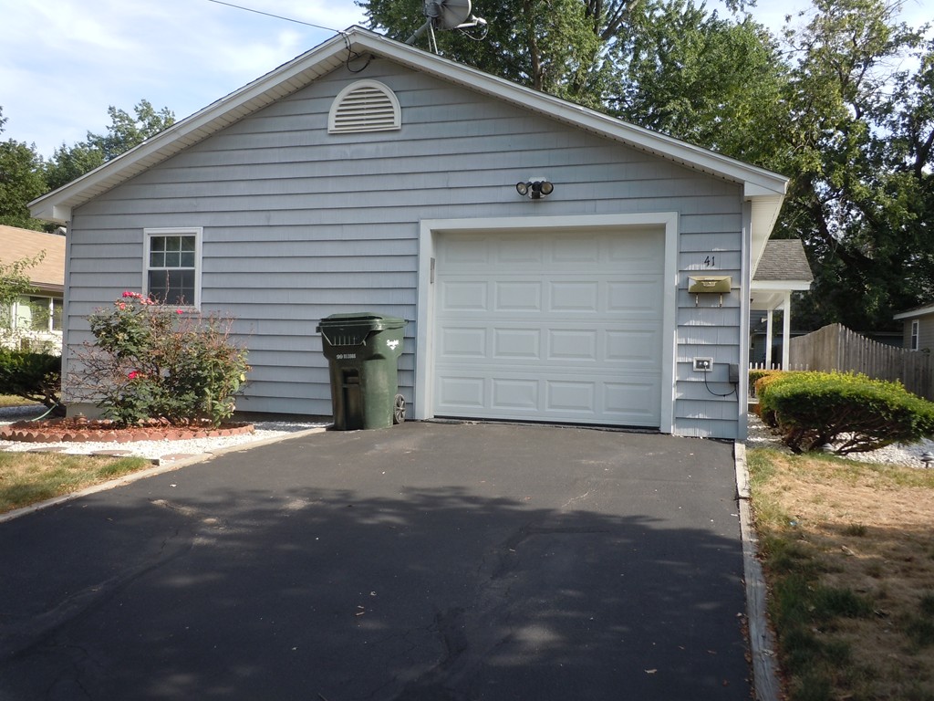 41 Blodgett Street Springfield, MA 01108 - Photo 18 of 23 a front view of a house with a yard and garage