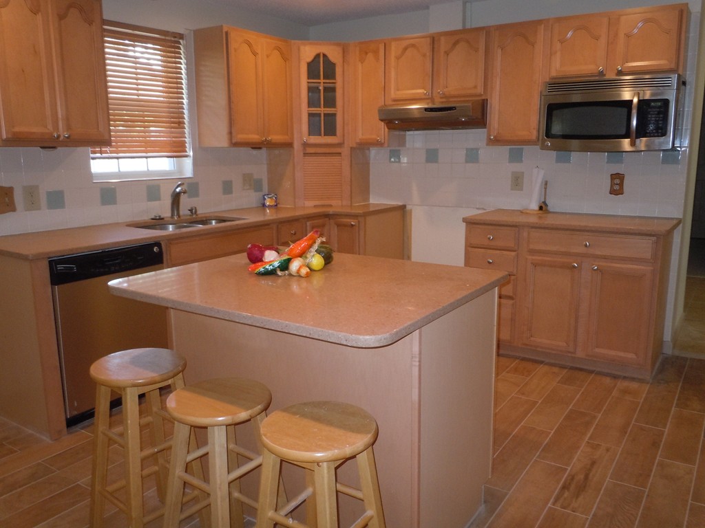 41 Blodgett Street Springfield, MA 01108 - Photo 5 of 23 a kitchen with stainless steel appliances a stove a sink cabinets and a dining table