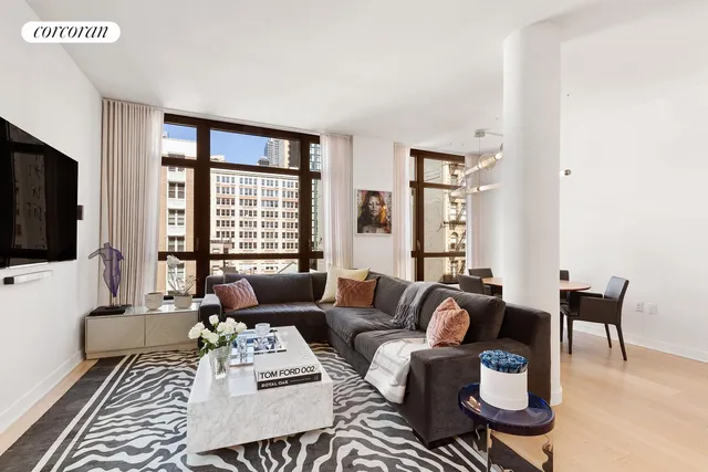 a living room with furniture a flat screen tv and a large window