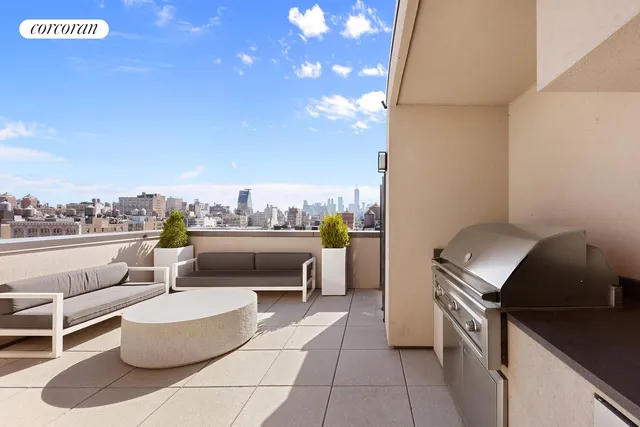 a view of a terrace with furniture and city view