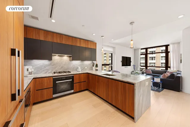a large kitchen with stainless steel appliances kitchen island granite countertop a sink and cabinets