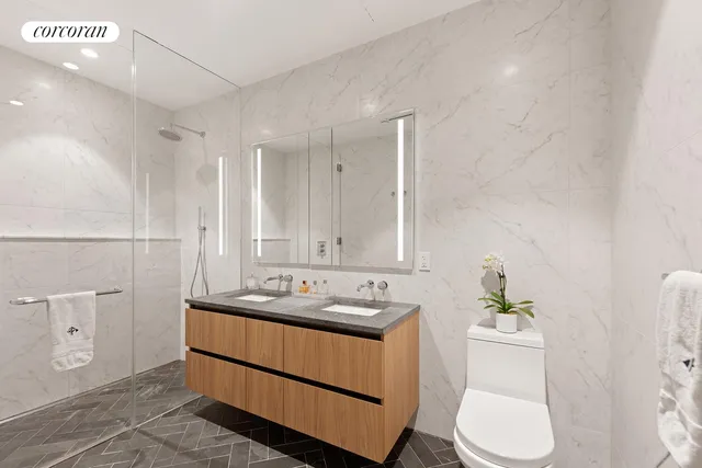 a bathroom with a sink a toilet and mirror