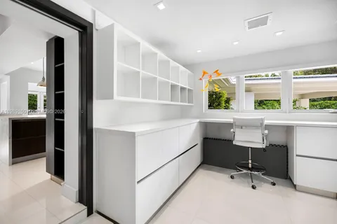 a view of an empty room with closet and a window