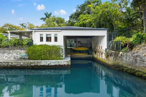 a view of house with swimming pool and outdoor seating