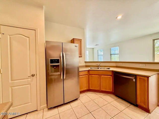 a kitchen with stainless steel appliances granite countertop a refrigerator and a sink