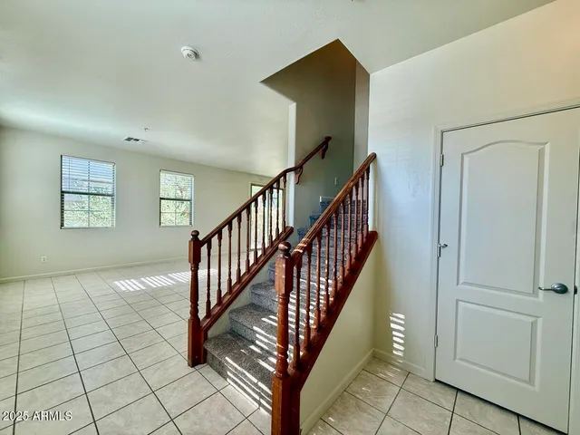 a view of a hallway with windows and stairs