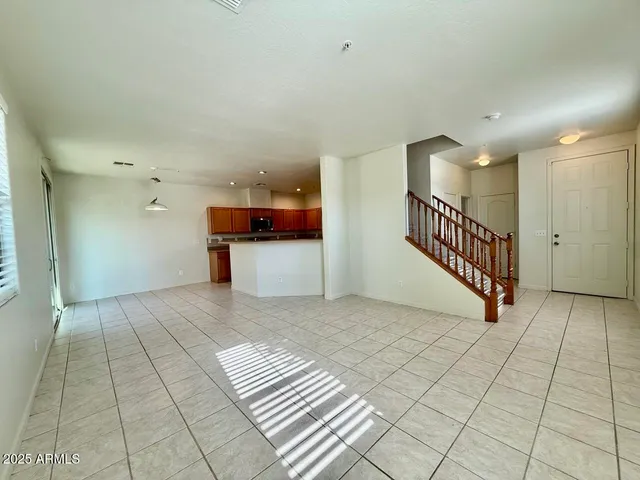 a view of a hallway with closet and a large window