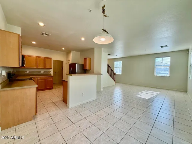 a view of a kitchen with furniture and wooden floor