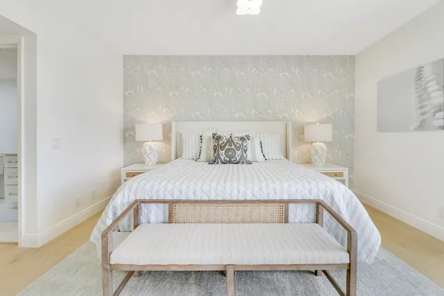 a bedroom with a large bed and a large window